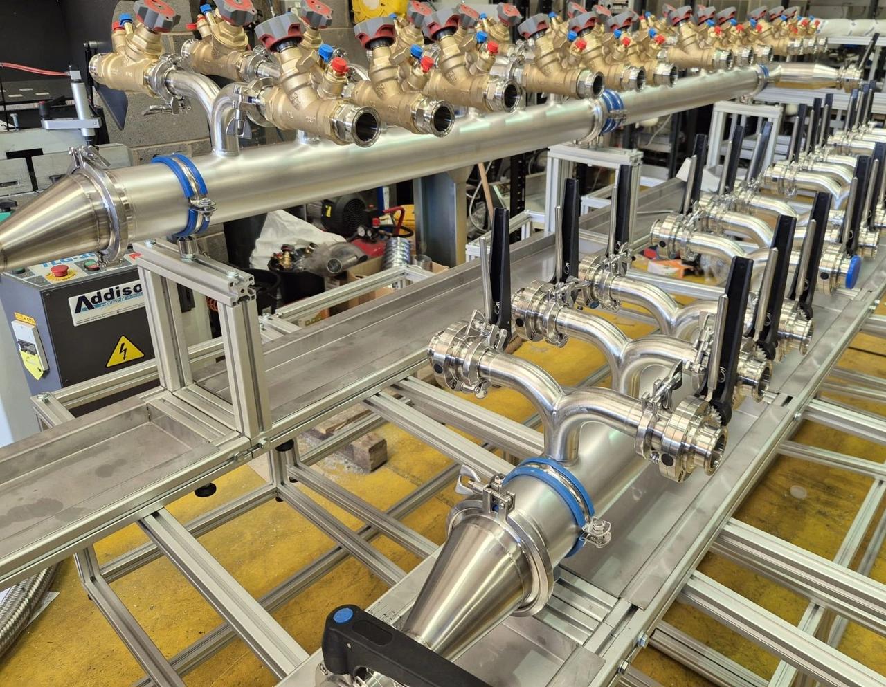 Completed cooling manifold mounted on aluminum extrusion frame with controller, presentation-quality build