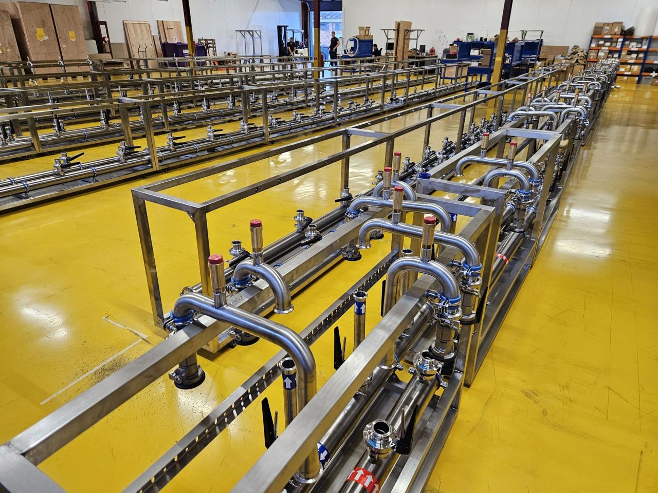 Production floor with U-bend stainless steel riser manifolds prepared for shipment