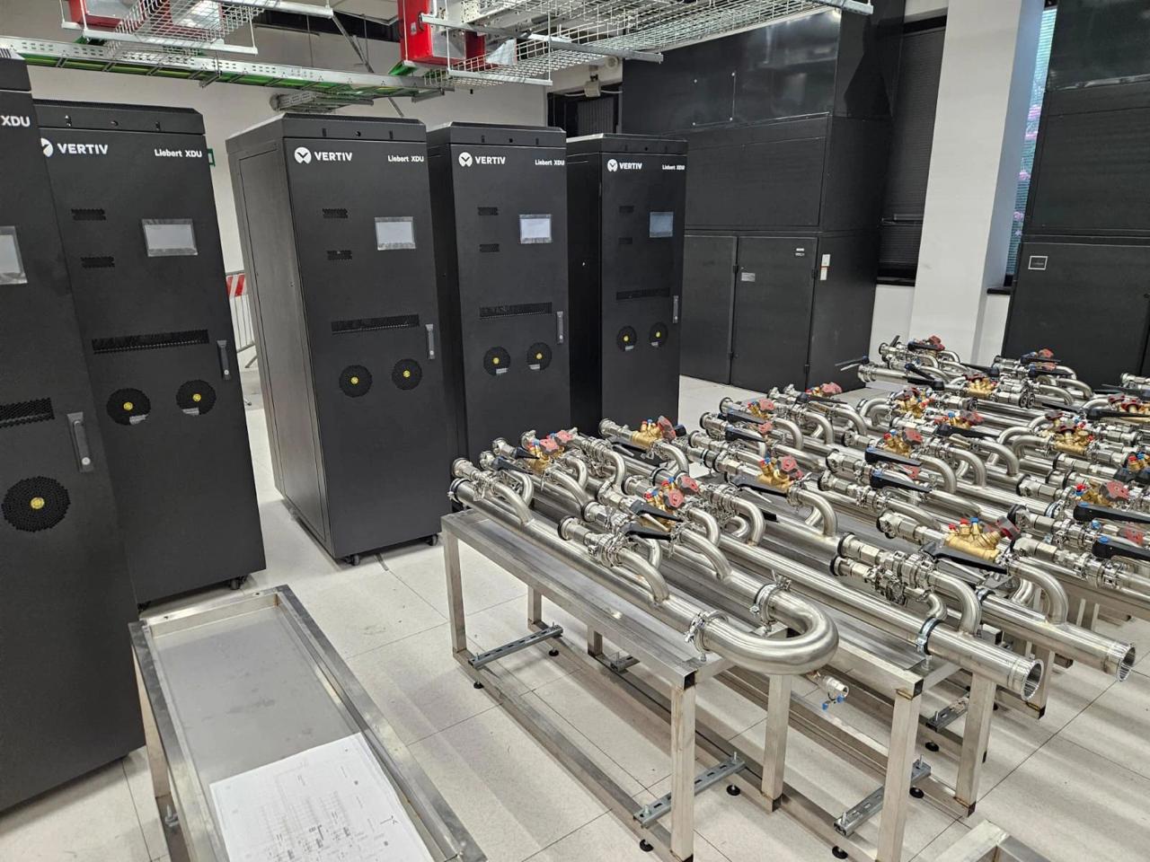 VERTIV Liebert XDU CDU cabinets staged with stainless cooling manifold in data center hall